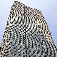 A tall building with a lot of windows against a blue sky.