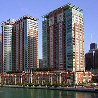 A group of tall buildings sitting next to each other next to a body of water.