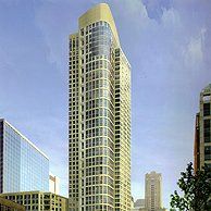 A tall building with a lot of windows is in the middle of a city.