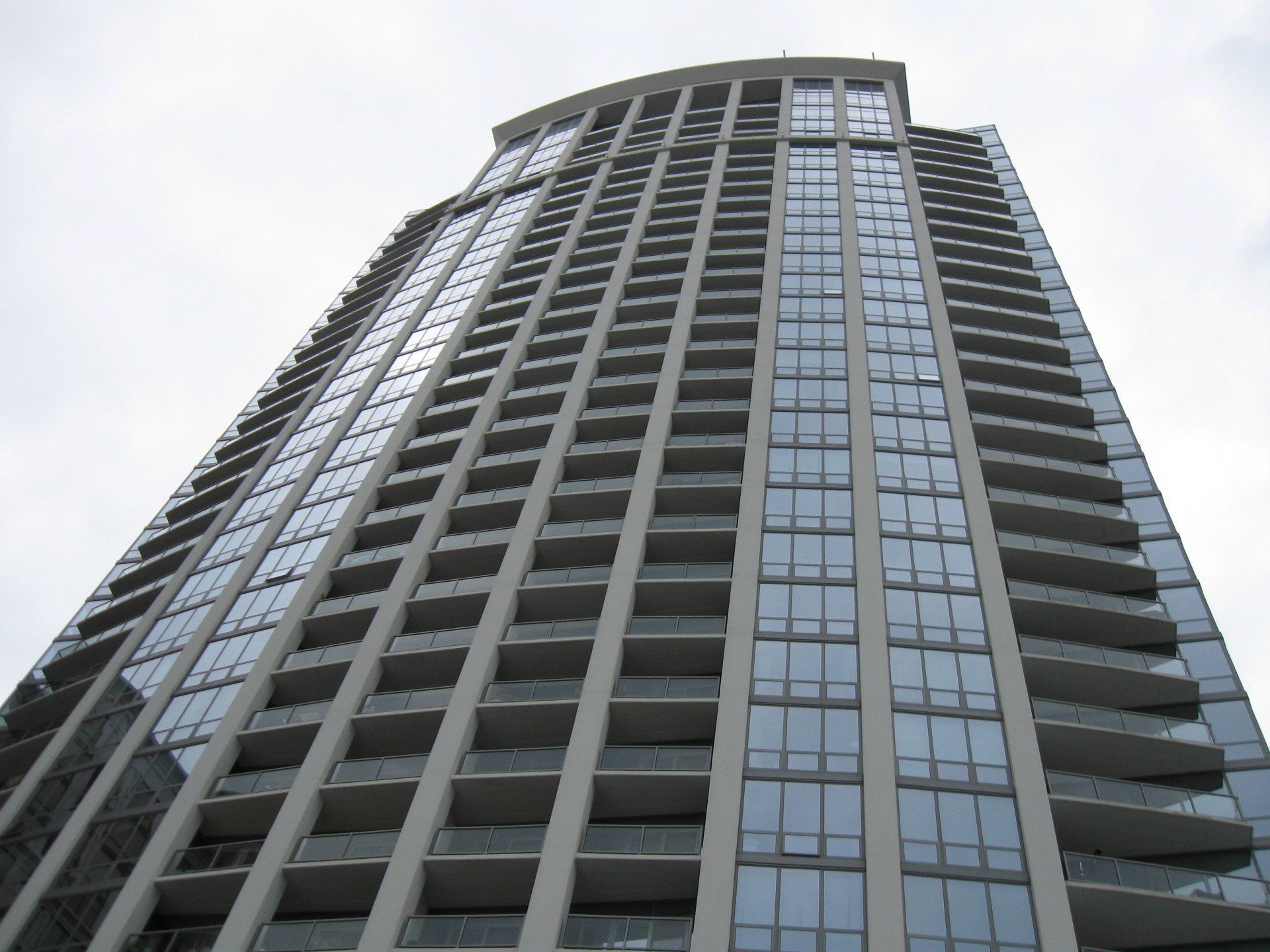 Looking up at a tall building with lots of windows