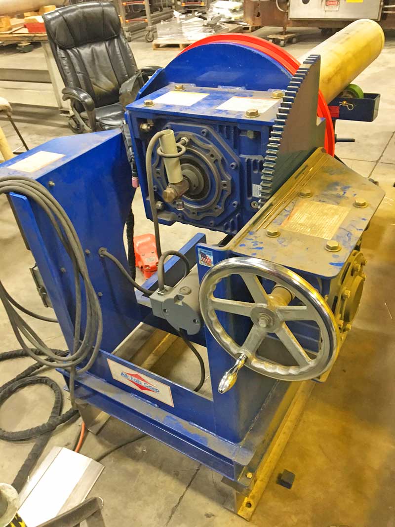 A blue and yellow machine with a chair in the background