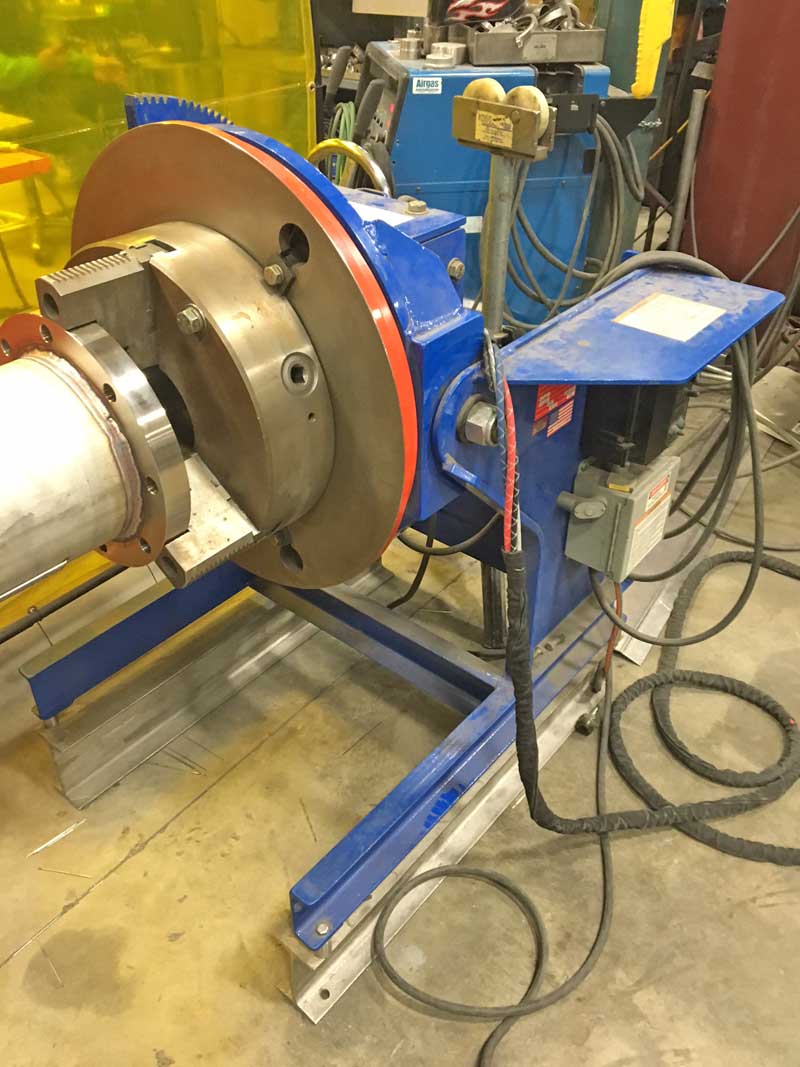 A machine is sitting on a concrete floor in a factory.