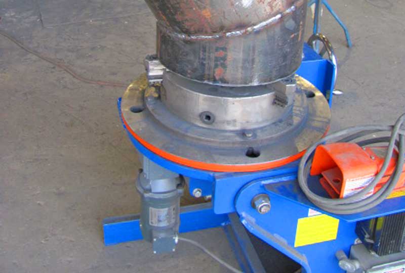 A blue and orange machine is sitting on a concrete floor.