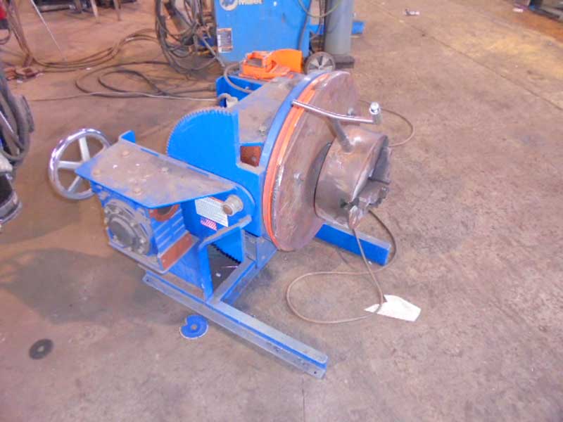 A blue machine is sitting on a concrete floor