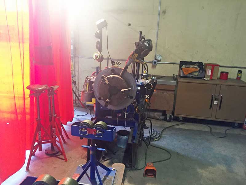 A machine in a room with a red curtain behind it