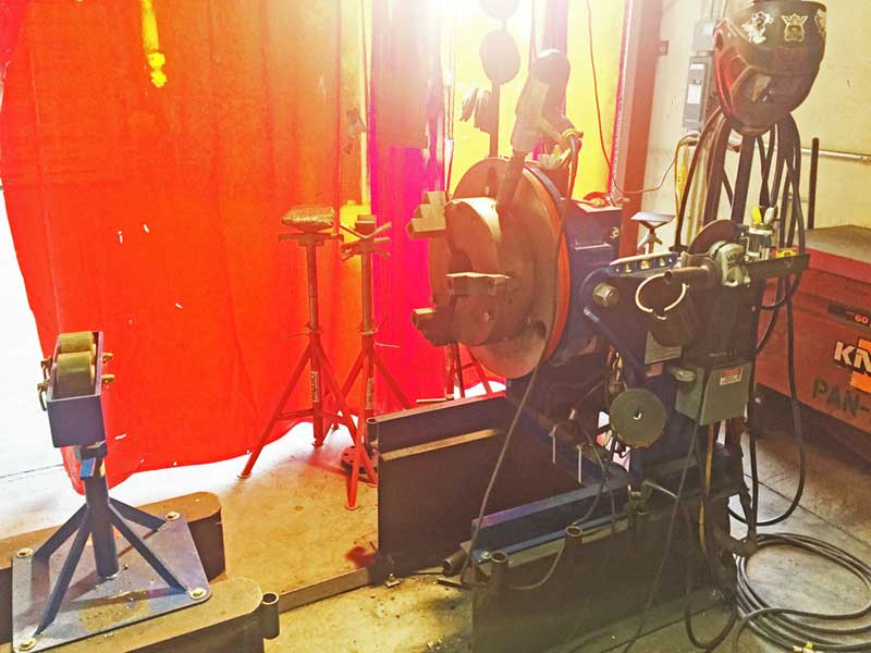 A machine is sitting in a room with a red curtain behind it