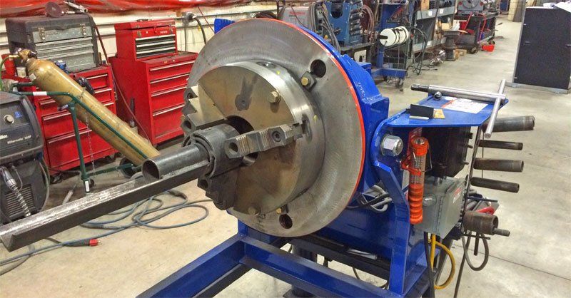 A machine is sitting on a cart in a factory.