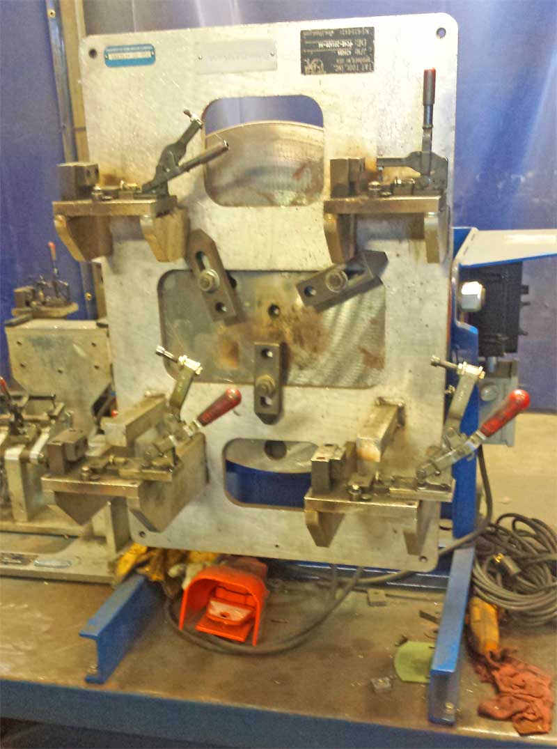 A machine is sitting on a table with a red foot pedal