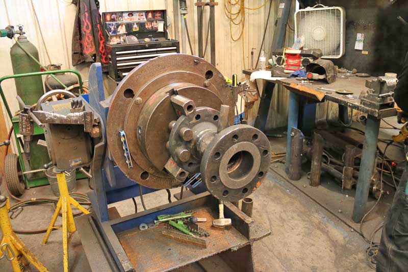 A large metal object is sitting on top of a table in a workshop.
