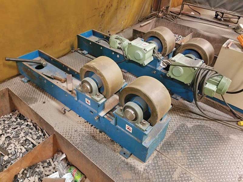 A pair of rollers are sitting on top of a metal surface.