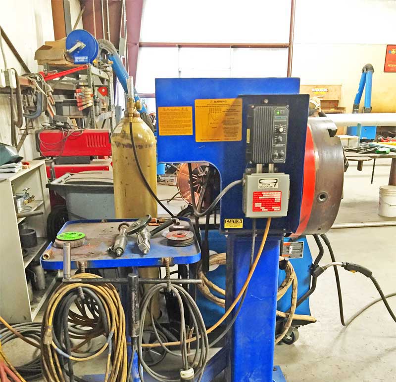 A blue machine with a warning label on it