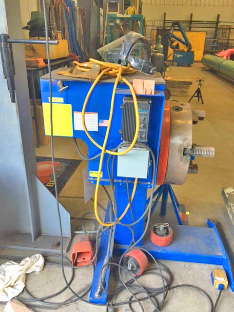 A blue machine with a lot of wires attached to it