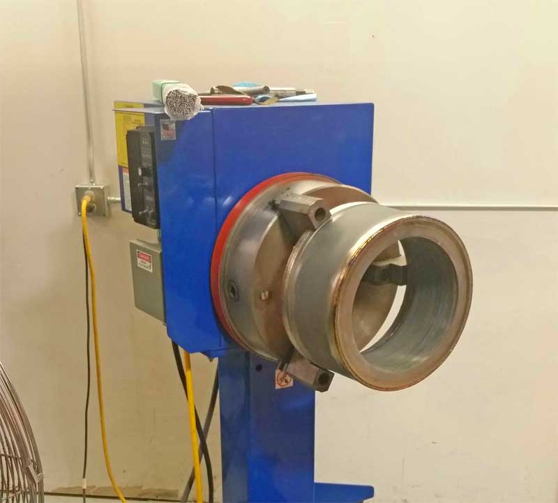 A blue machine with a large metal cylinder on it