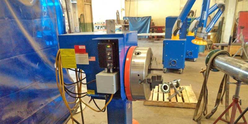 A machine is sitting on a wooden pallet in a factory.
