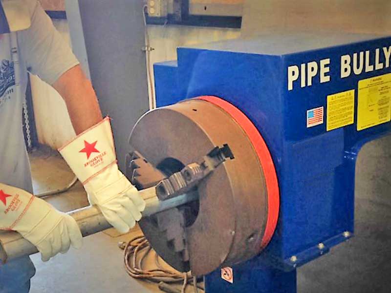A person is working on a pipe built machine