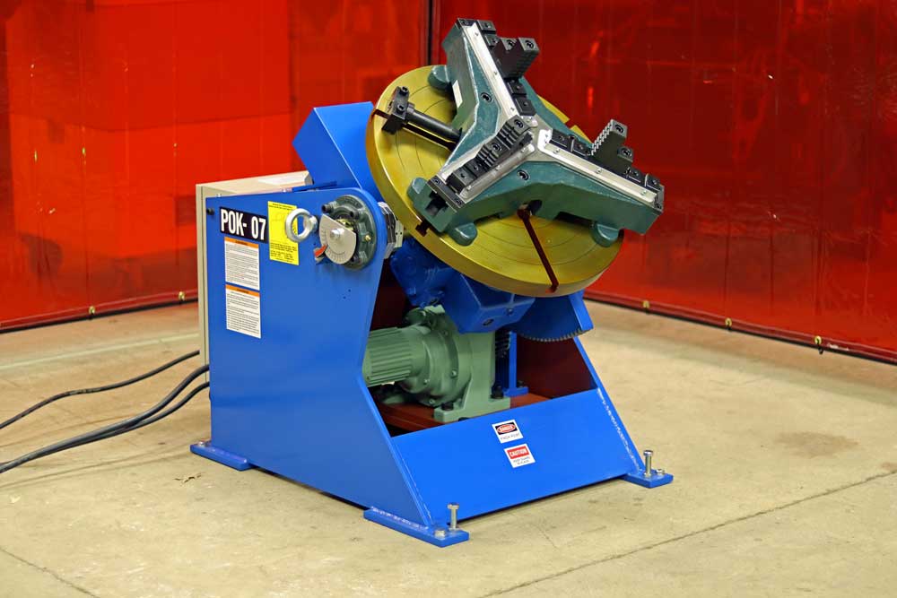 A blue and yellow machine is sitting on the floor in a room.