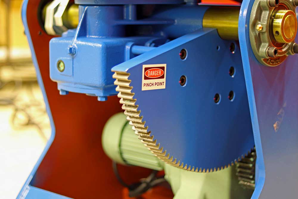 A blue machine with a danger sign on it