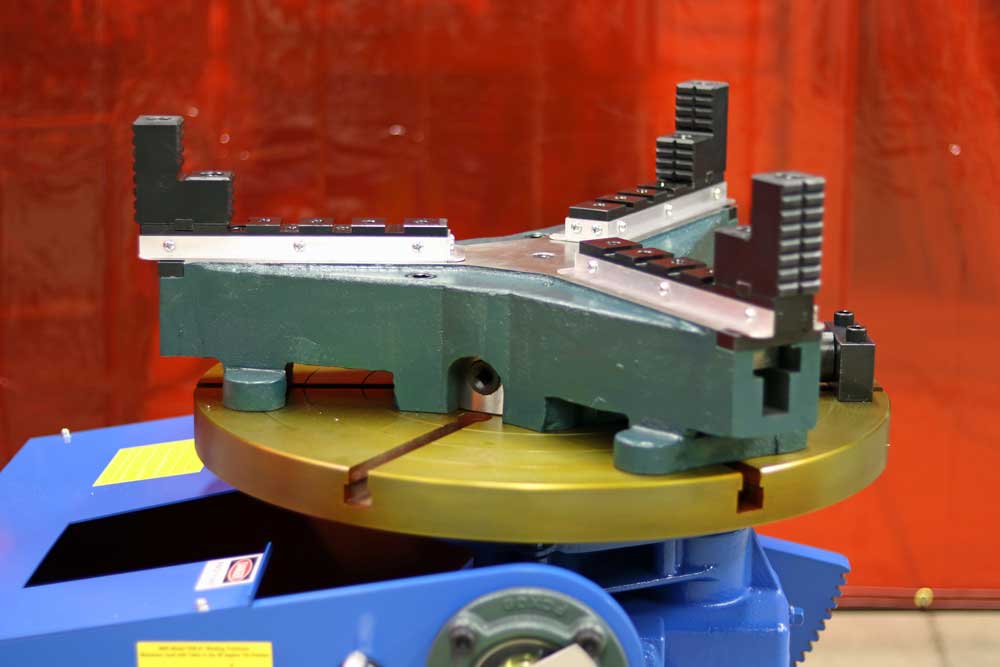 A machine is sitting on a table with a red curtain in the background.