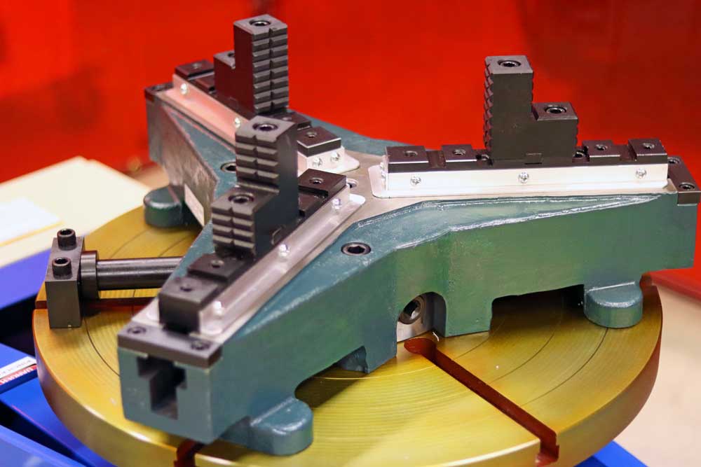 A close up of a machine on a table with a red background