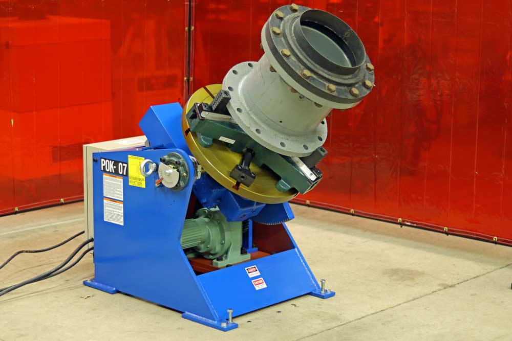 A machine is sitting in a room with a red curtain behind it