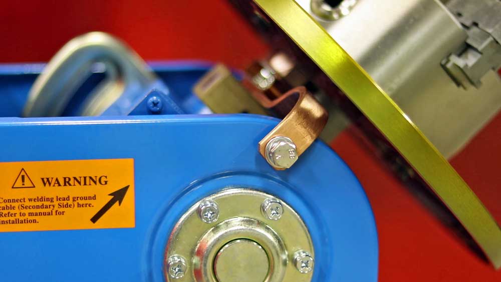 A close up of a machine with a warning label on it