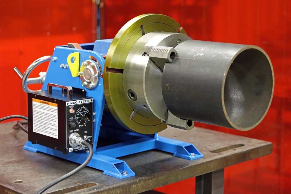 A machine is sitting on a table with a pipe in it.