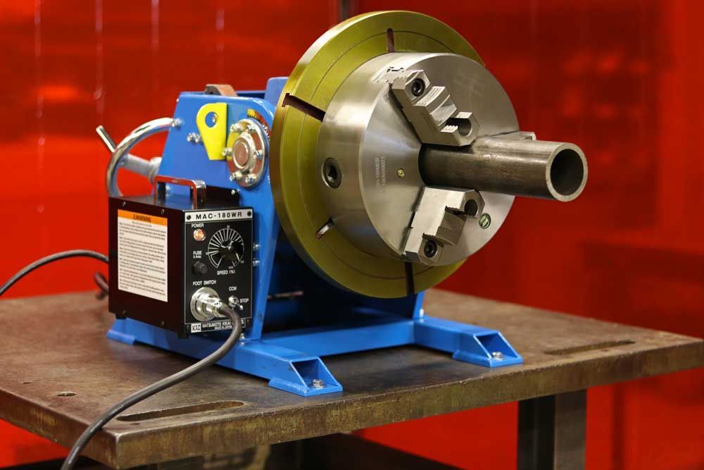 A machine is sitting on a table with a pipe in it.