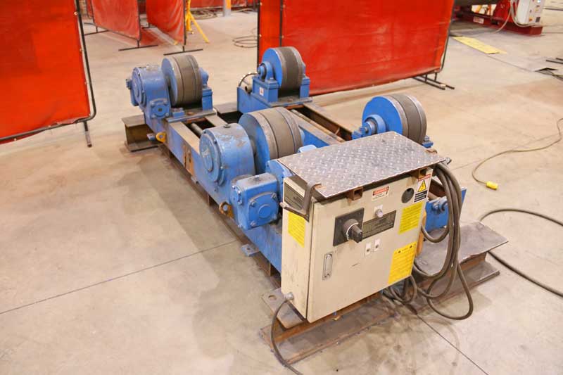 A machine is sitting on the floor in a warehouse.