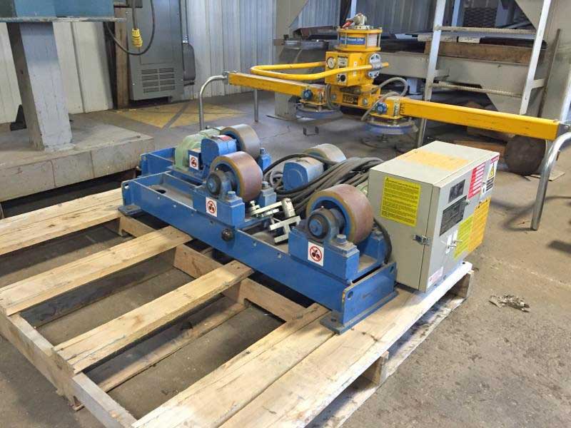A machine is sitting on a wooden pallet in a factory.