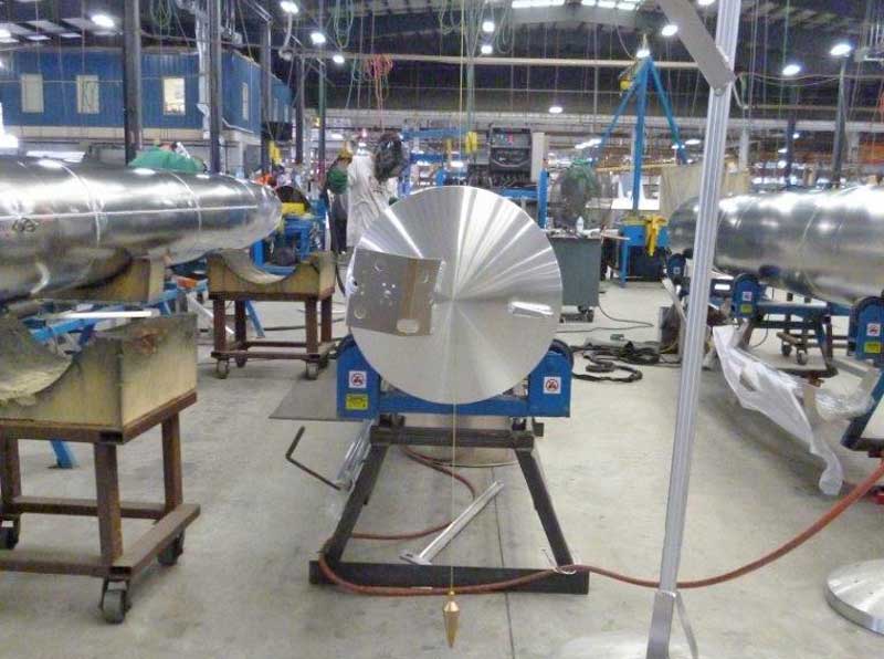 A large metal object is sitting on a table in a factory