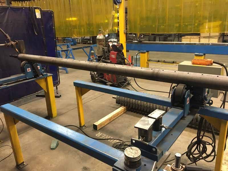 A welding machine is sitting on a table in a factory.