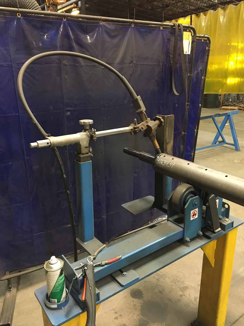 A machine is sitting on a table in front of a blue curtain.