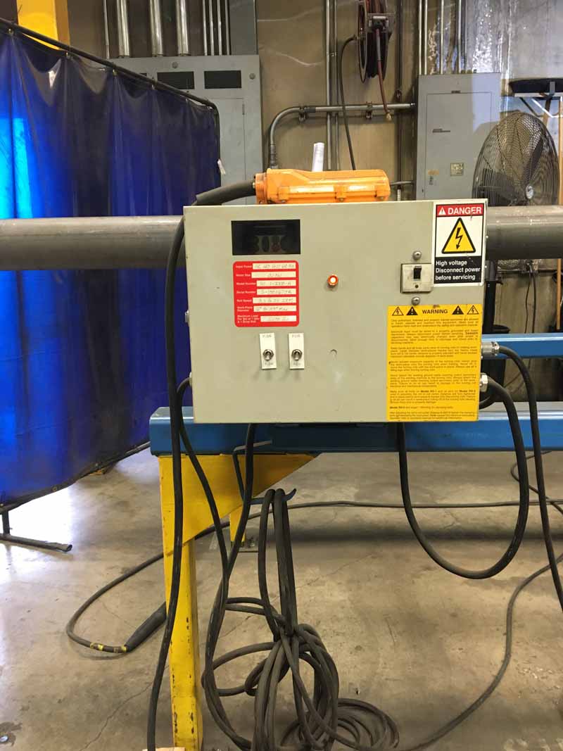 A welding machine is sitting on a table in a factory.