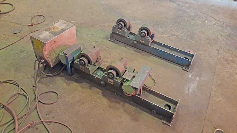 A couple of metal pieces sitting on top of a metal floor.