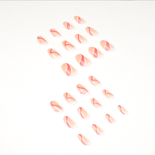 A close up of a woman 's nails with a pink and white design