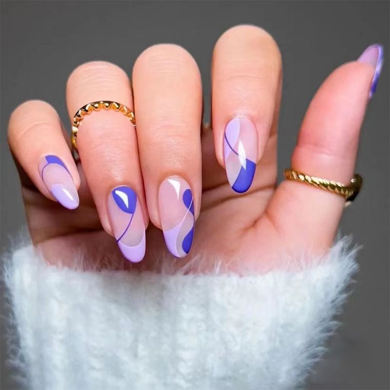 A close up of a person 's nails with rings on them.