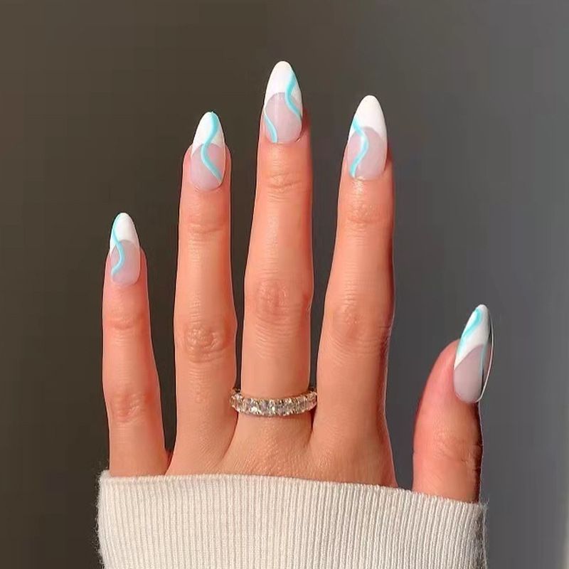 A close up of a person 's nails with a ring on their finger.