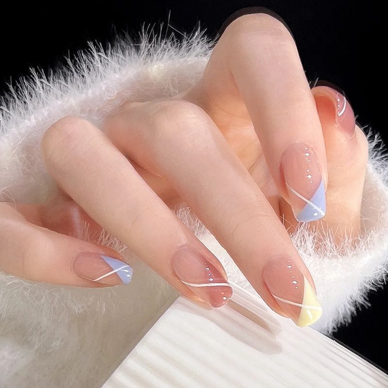 A close up of a person 's nails with a french manicure.