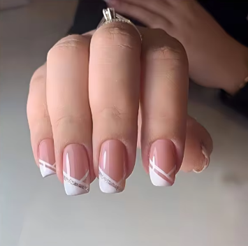 A close up of a woman 's nails with a ring on her finger.