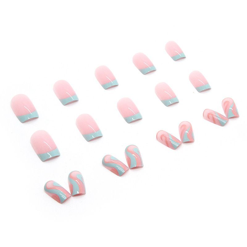 A woman 's hand with pink and blue nails and a wave ring