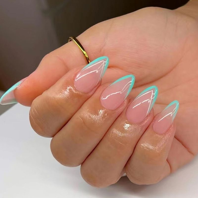 A woman 's hand with long nails and a ring on her finger