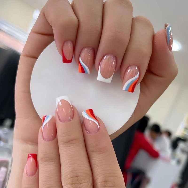 A close up of a woman 's nails holding a white circle