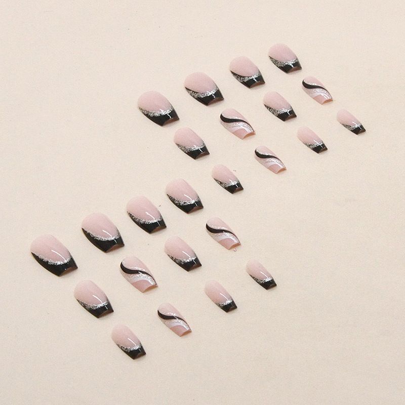 A close up of a woman 's nails with a black and silver design