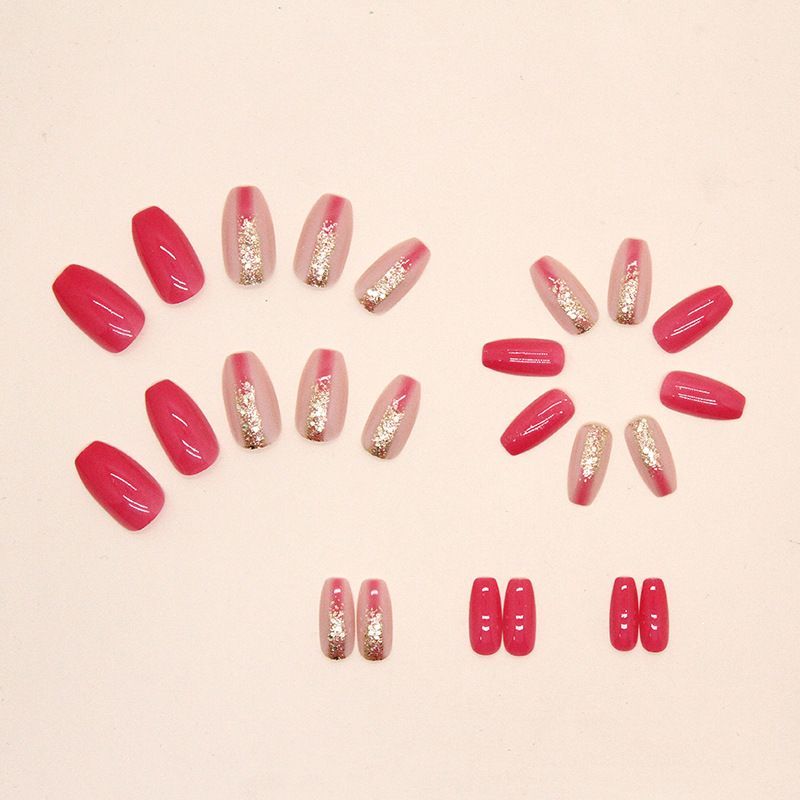 A close up of a woman 's pink nails with gold glitter