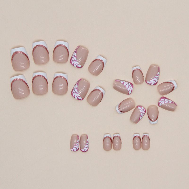 A close up of a woman 's nails with a floral design on them.