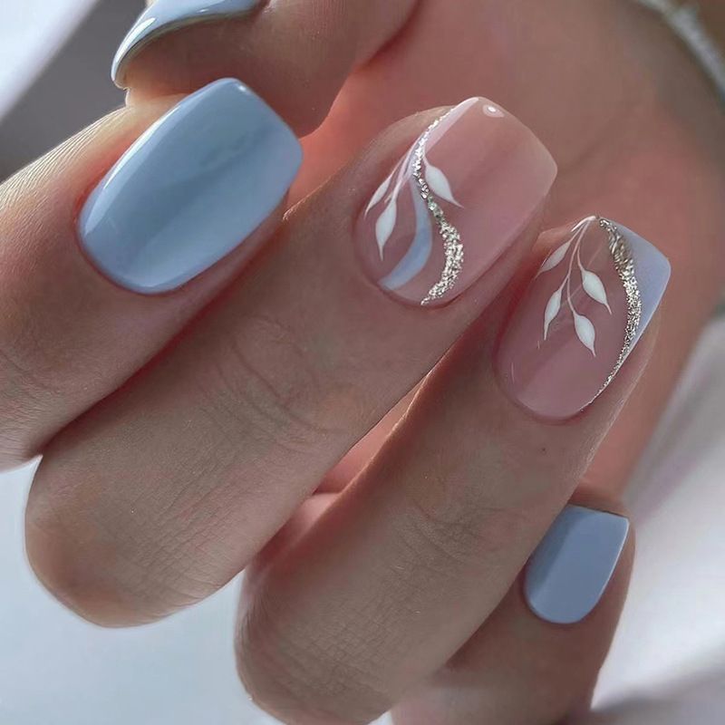 A close up of a woman 's nails with a design on them