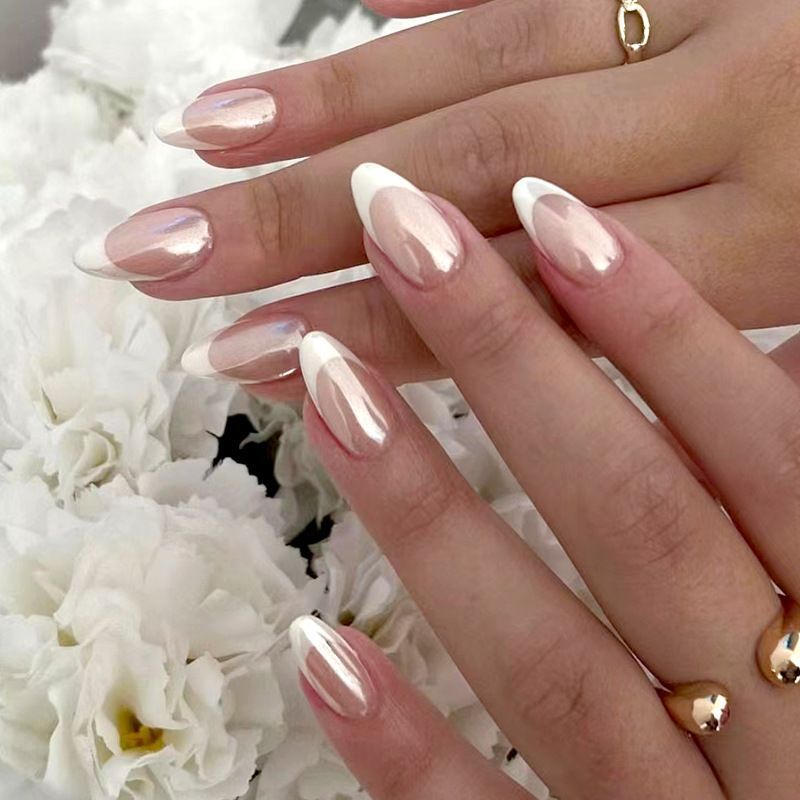 A close up of a woman 's nails with flowers in the background