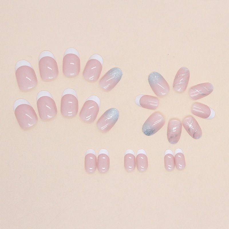 A close up of a woman 's nails with a ring on her finger