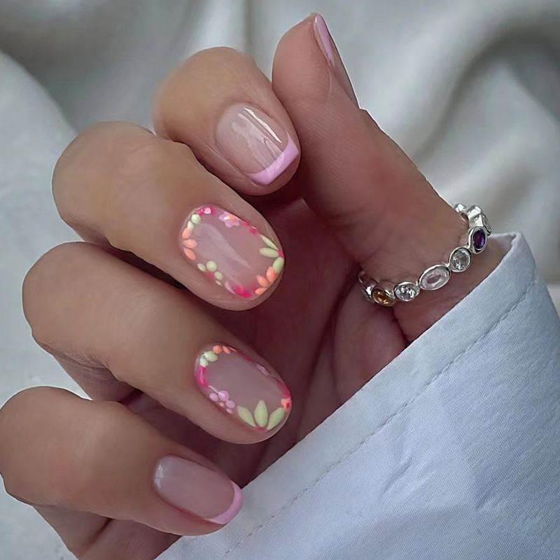 A close up of a woman 's nails with a ring on her finger