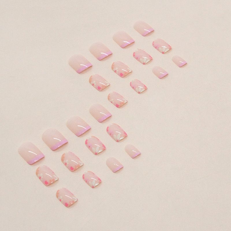 A close up of a woman 's nails with a ring on her finger